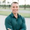 a man in a green shirt is posing for a picture